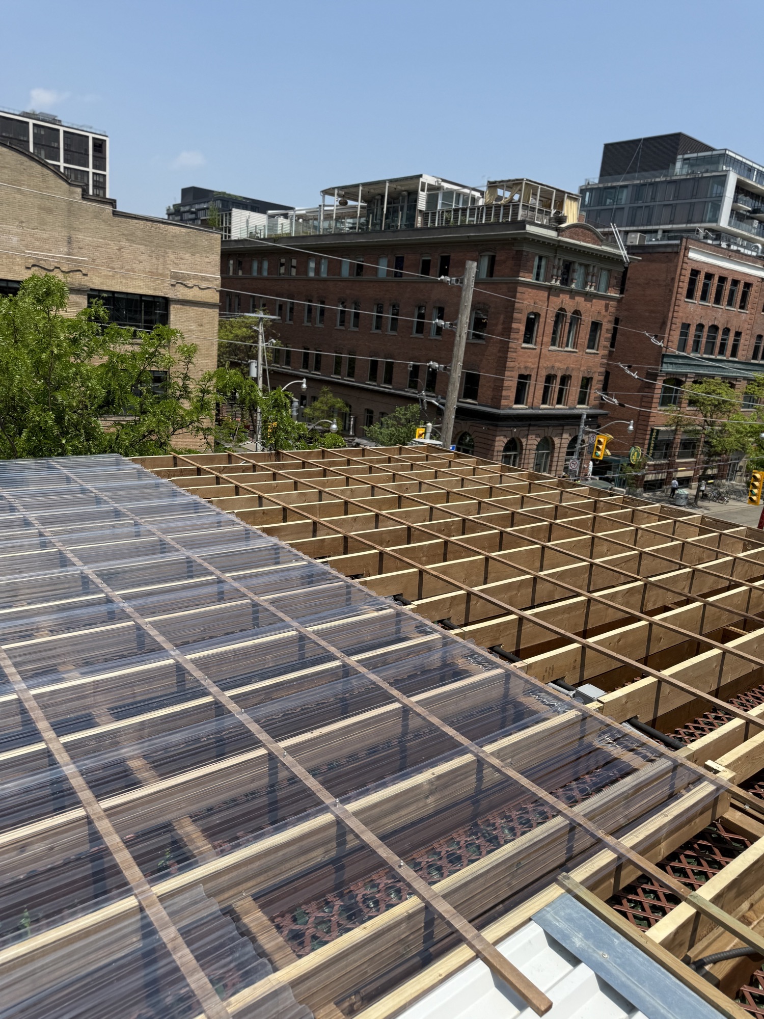 King St. East — clear roofing panels being fastened