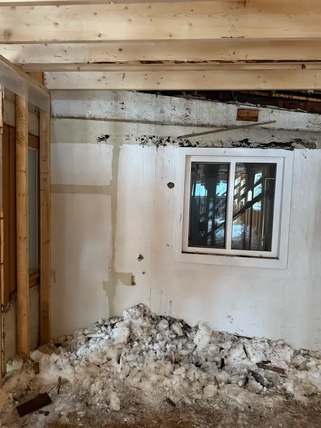 Interior stripped to the framing, mid-demolition