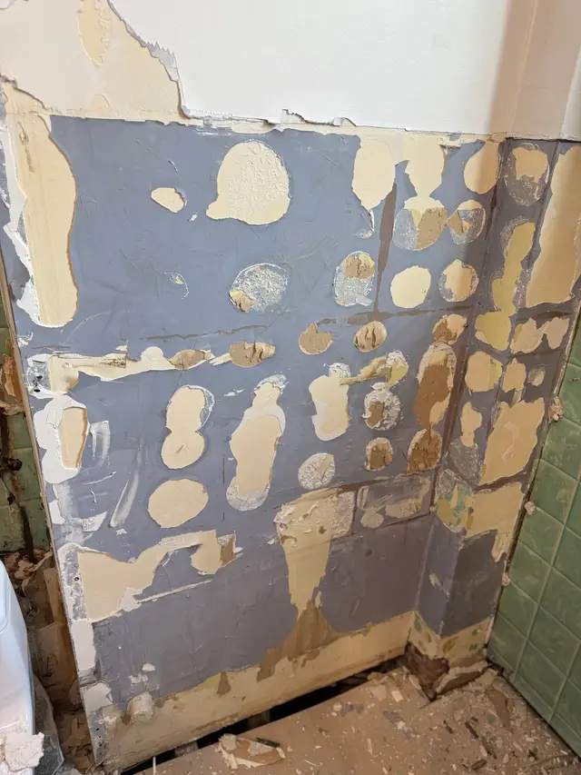 Bathroom wall with the old tile stripped off