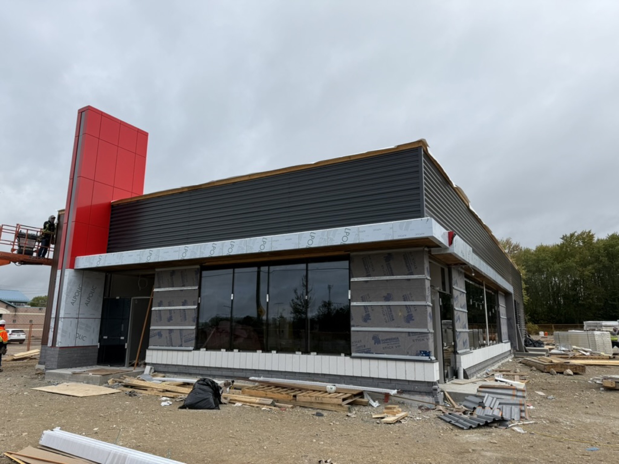 Elora — signage tower up, exterior cladding underway