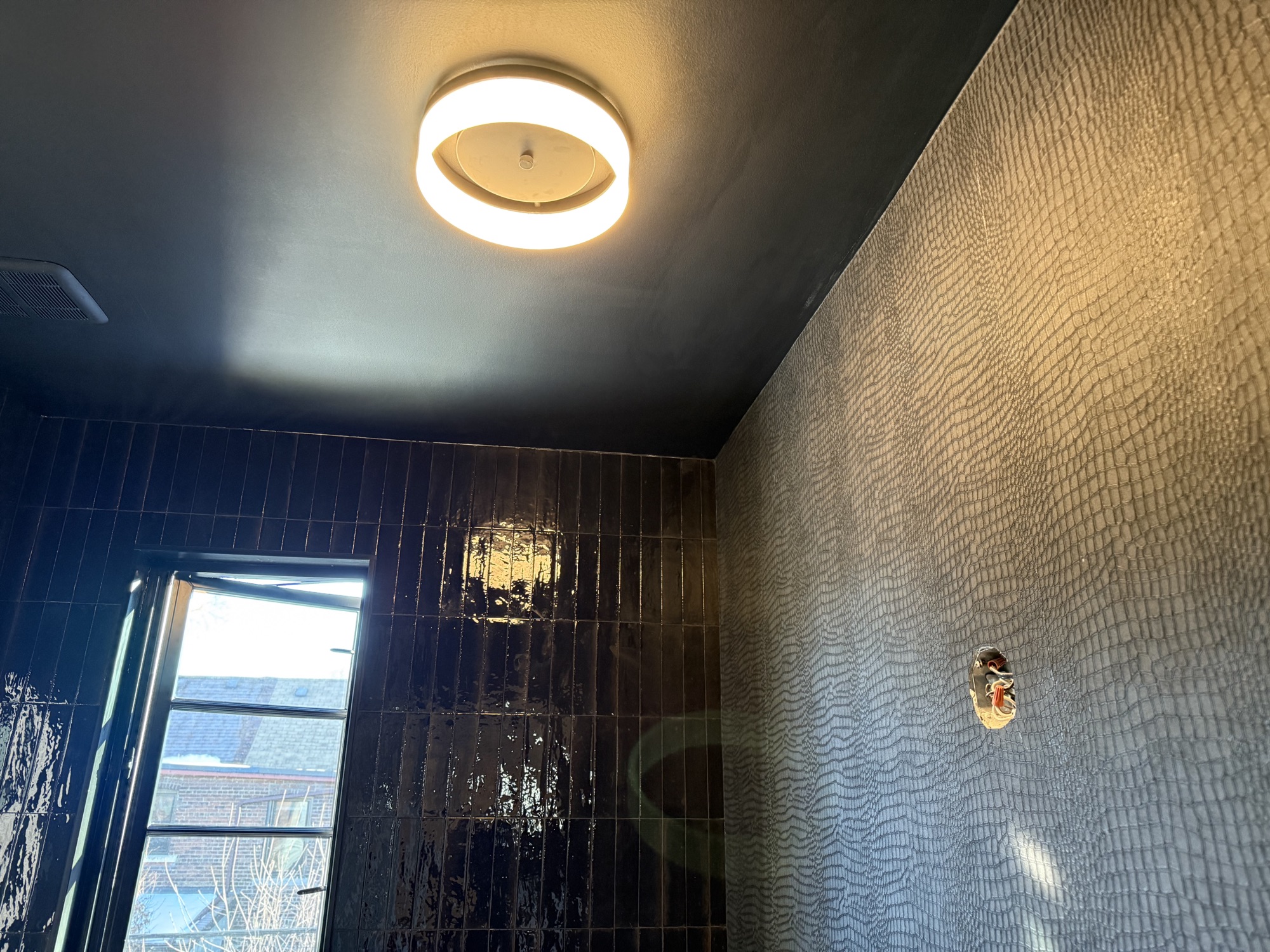 Leslieville — black tile, textured wallpaper and a dark ceiling
