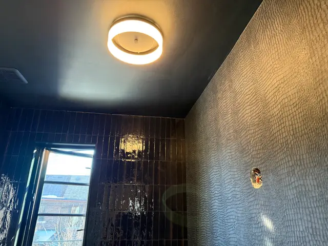 Leslieville — black tile, textured wallpaper and a dark ceiling