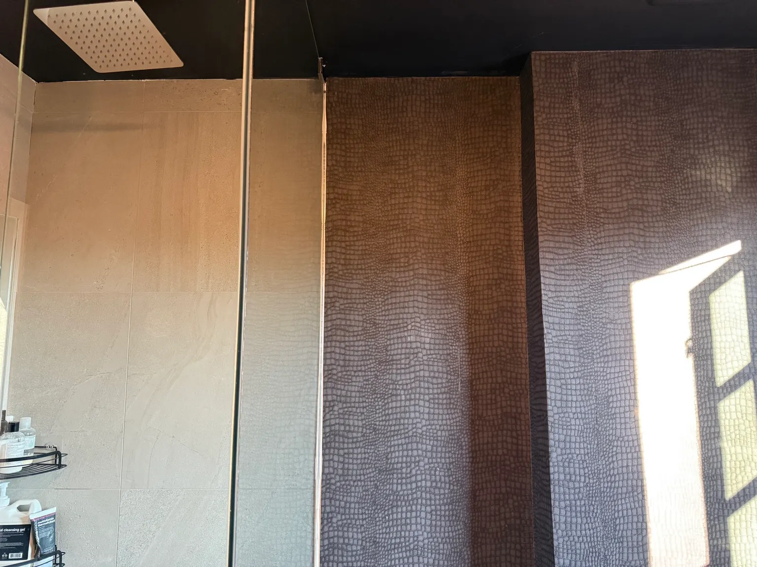 Finished bathroom with painted ceiling, wallpaper and tile